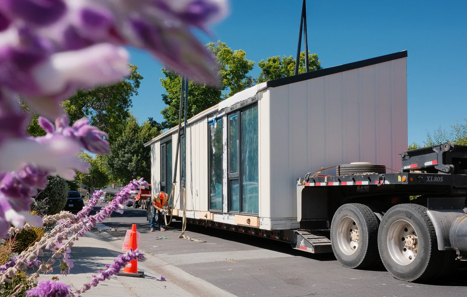 A full-scale LiveLarge residential module arriving at a project site